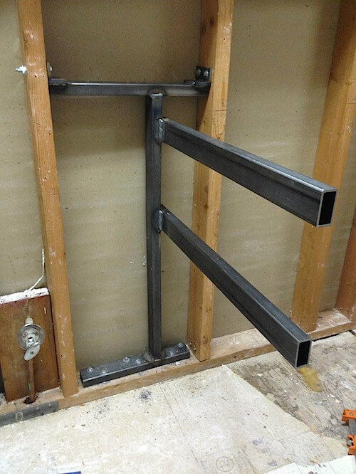 Steel support beams inside wall studs for Floating Cabinets