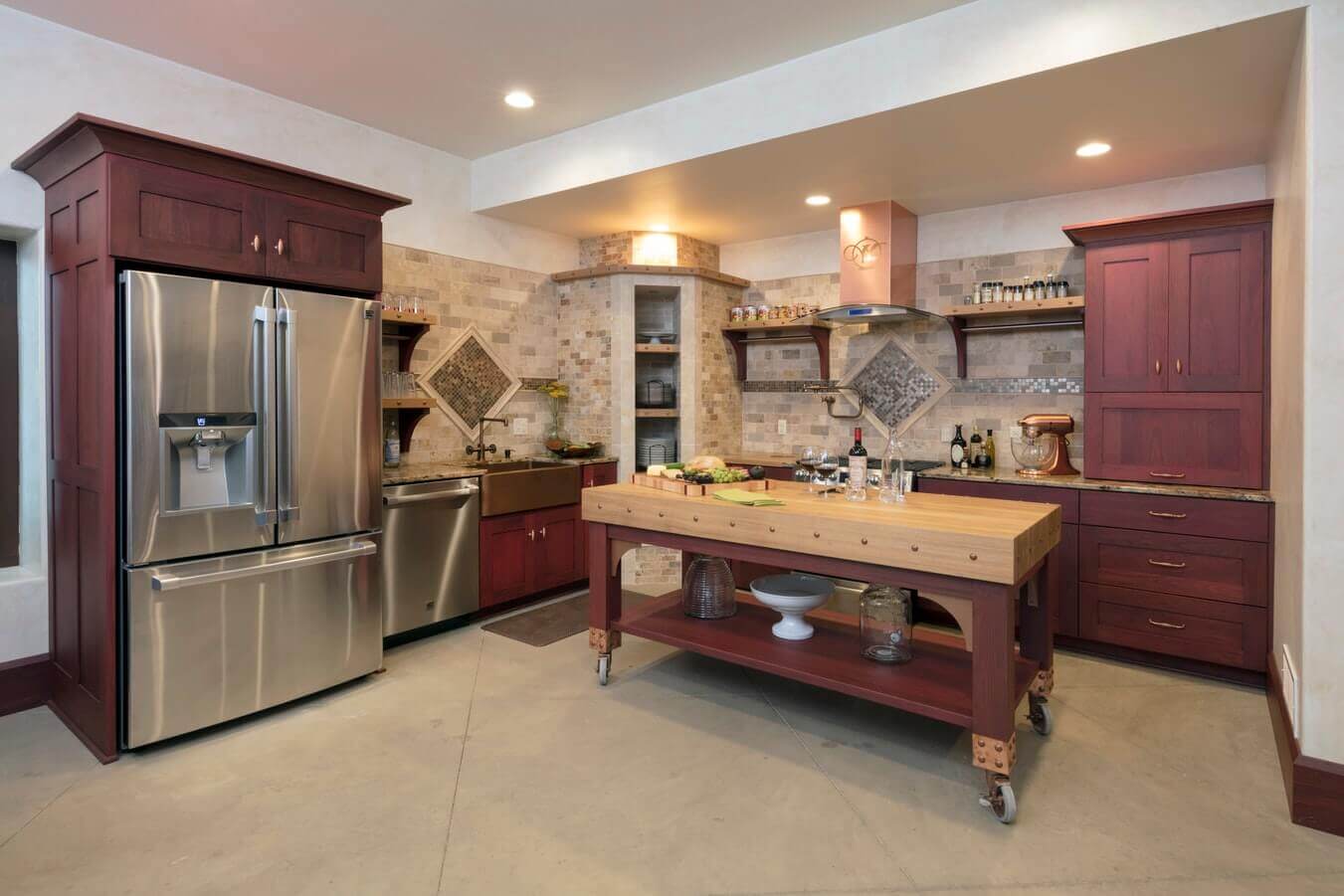 Kitchen with stone tile flooring and dark-red wooden cabinets